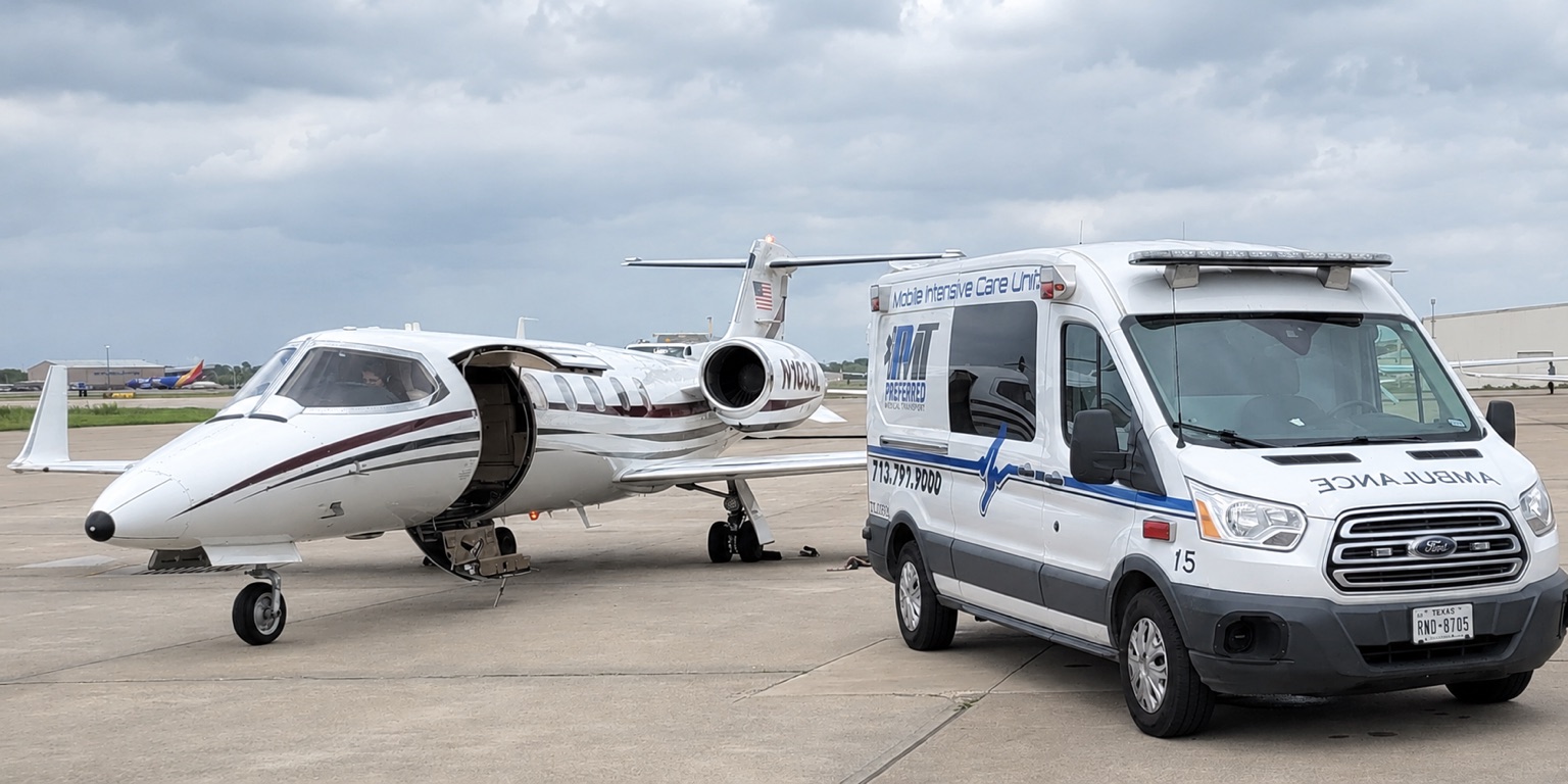 Preferred EMS MICU Unit 15 beside an aircraft on an airport ramp
